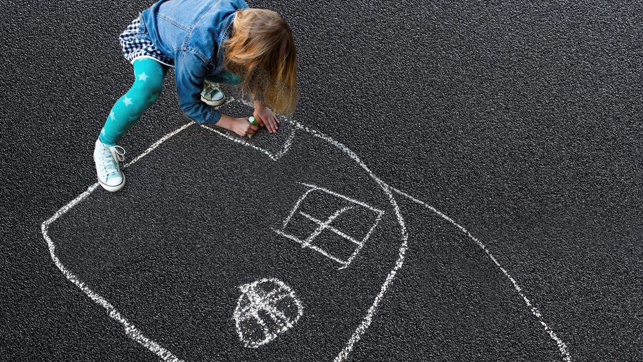 children drawing with chalk on asphalt