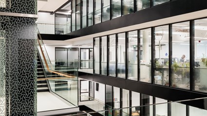 Asymmetrical pentagonal shape is degorating the building as outside than inside. The spape is visible e.g. in elevators and office walls.