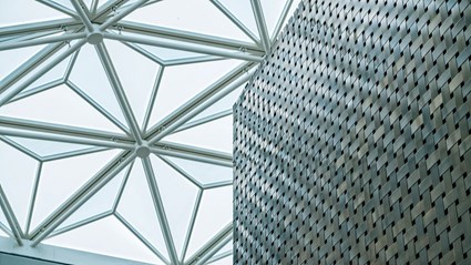 The atrium’s beautiful glass ceiling at the newly renovated Nationalmuseum lets the light in. Part of the elevator shaft is seen with a surface of braided brass.