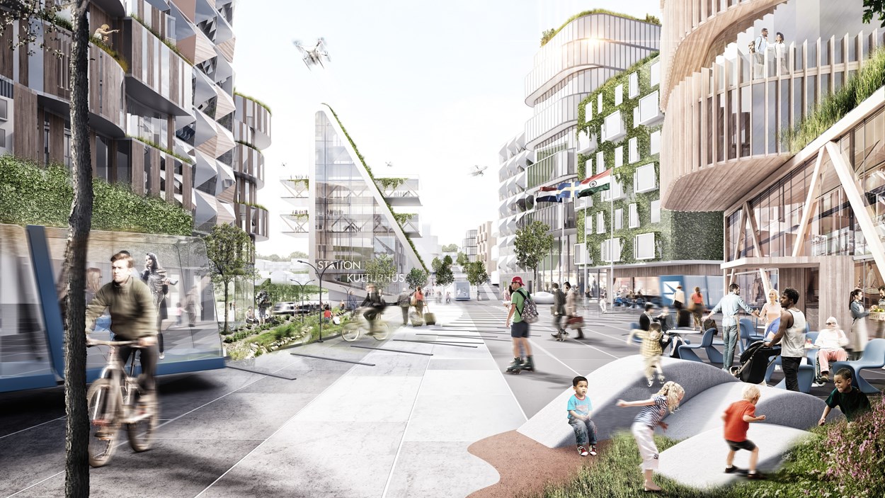 Framtidsbild av hur den nya staden Landvetter södra kommer kunna se ut. Rektangulärt station- och kulturhus med stora glaspartier, mycket grönska både i rabatter och på husfasader och människor i rörelse.