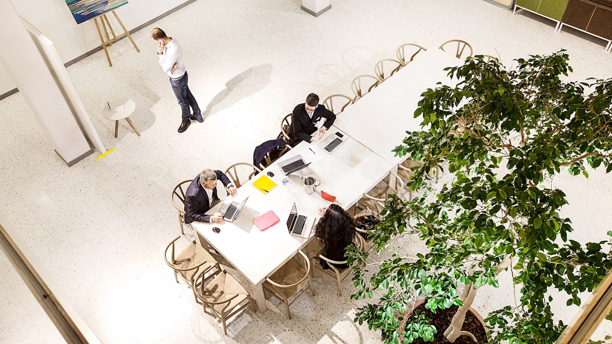 People with computers having a meeting.