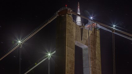 The height of the pylons is 180 meters. They are crowned by 12 meter high glass pyramids.