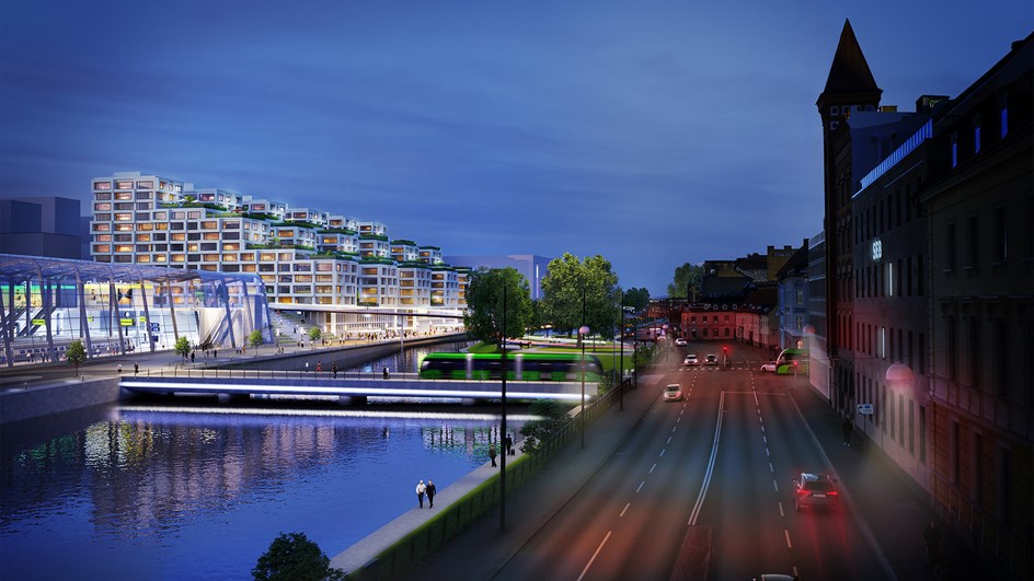 Rendering med befintlig stadsbyggnad, kanal, broar och ett överbyggt stationsområde. Man ser spåren genom ett glastak och nya byggnader.