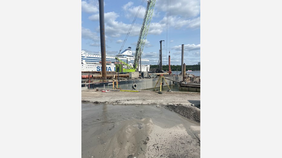 Large ferries dock adjacent to the worksite. The worksite with a ferry in the background.