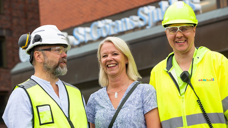 Carl Widegren, blockchef Logistik på Skanska, Marie Redén, områdeschef på Samhall och Chippen Ceccon, flaggvakt från Samhall framför St Görans Sjukhus i Stockholm.