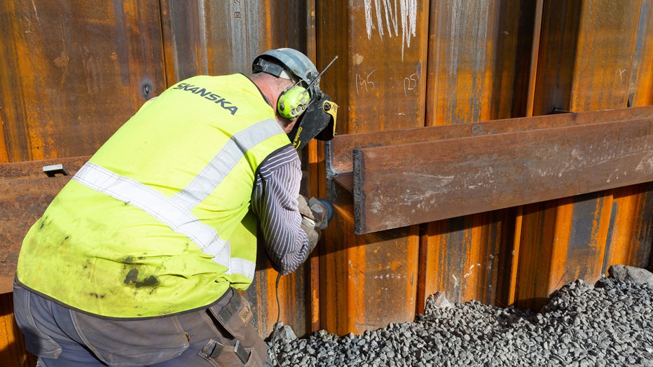 The river edge protection is welded to withstand the forces of nature. A construction worker is welding the river edge protection.