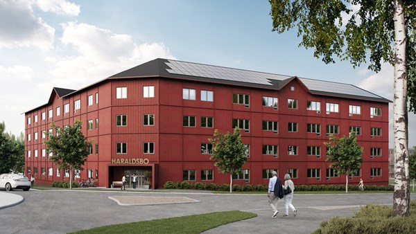 Rött femvåningshus i trä med solceller på taket – SÄBO Haraldsbo i Falun, byggt av Skanska och certifierat enligt LEED Guld